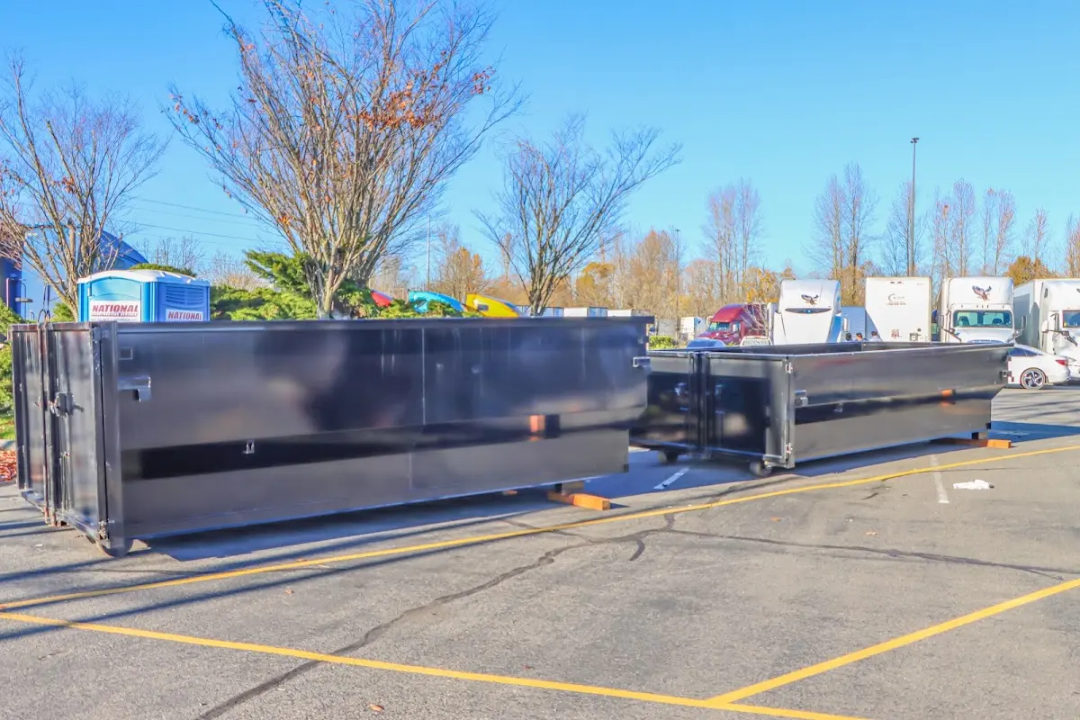 Professional dumpster rental service with roll-off container on residential driveway in Jefferson